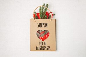 Brown bag with holiday items Support Local Businesses