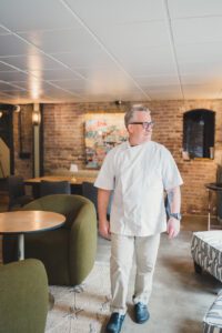 Photo of Chef Black Bethem walking in Bourbon Tasting Room at Ironclad Inn on Princess Anne Street in Fredericksburg, VA