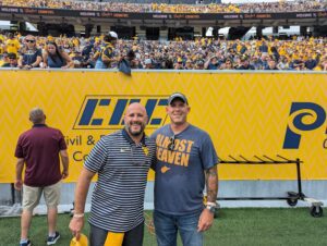 Josh Summits pictured with man at West Virginia University football game