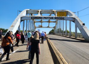 People walking onto bridge.