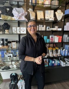 Woman standing in front of store display.