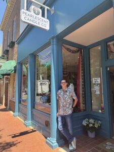 Eric Campbell standing on sidewalk in front of store.