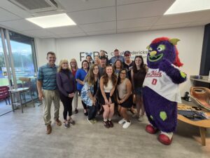 Group of people with FredNat's mascot.